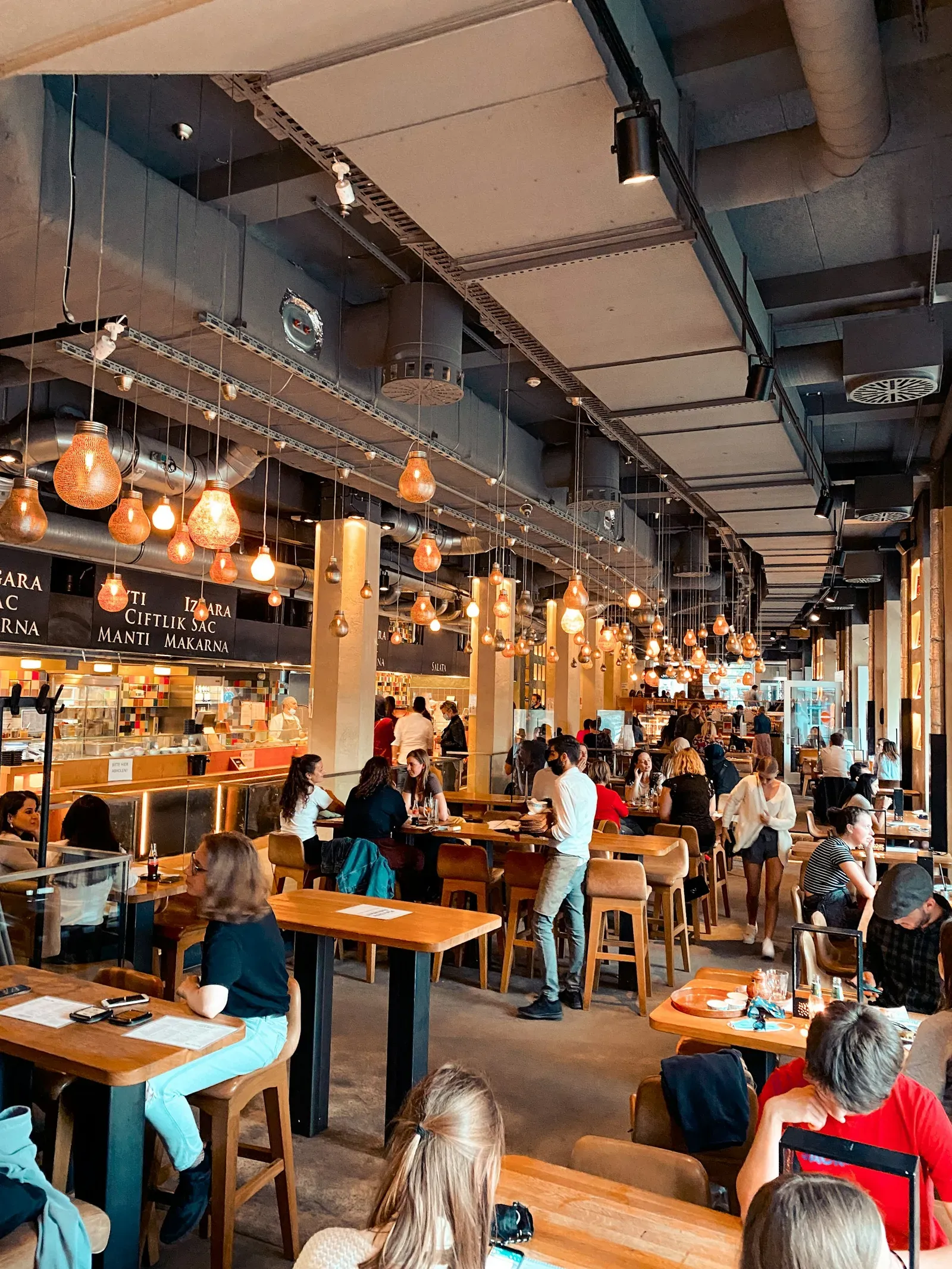 Busy restaurant dining room with an open kitchen counter